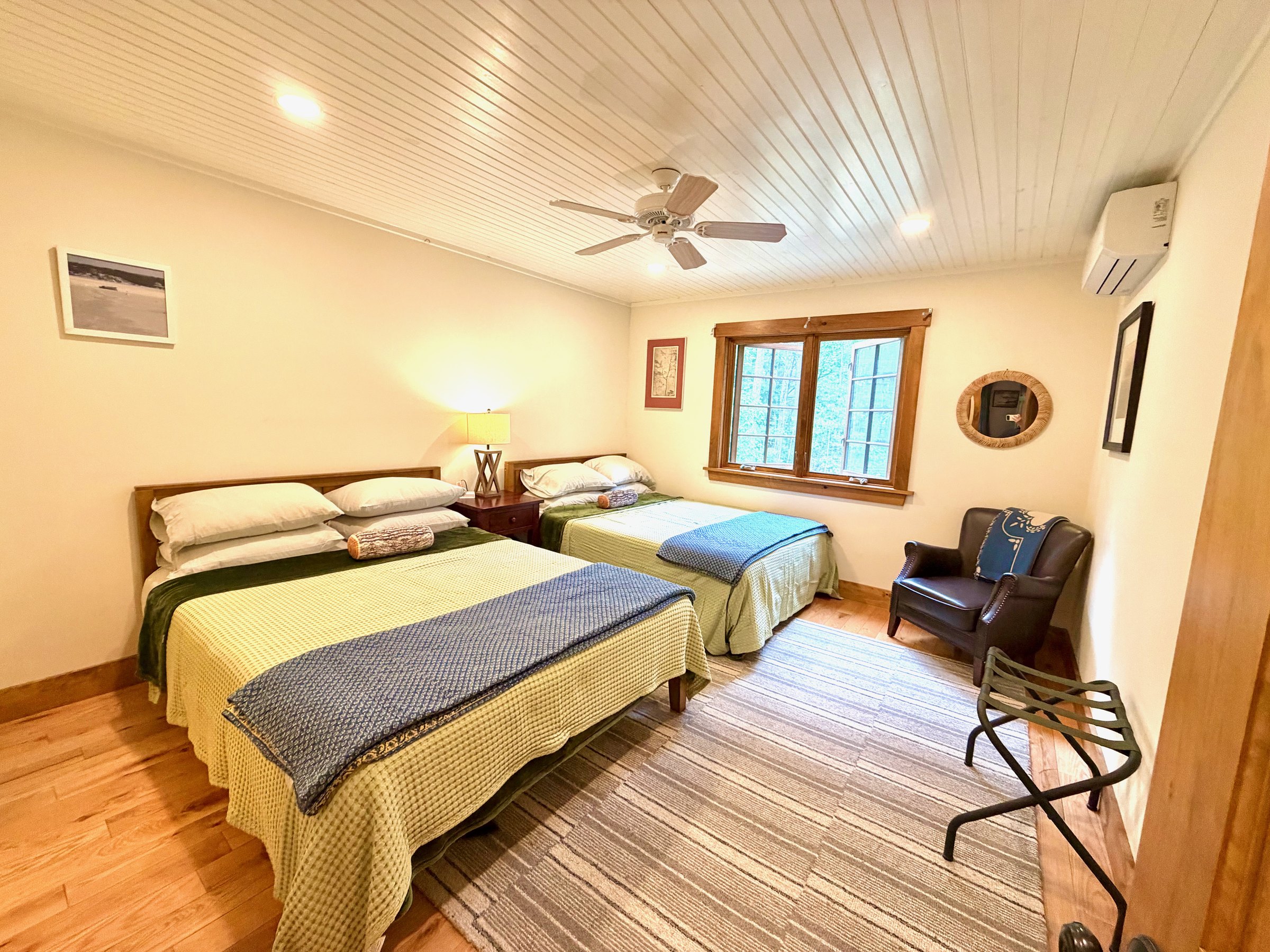 Tree Room bedroom with window seating at Wild Ausable Lodge