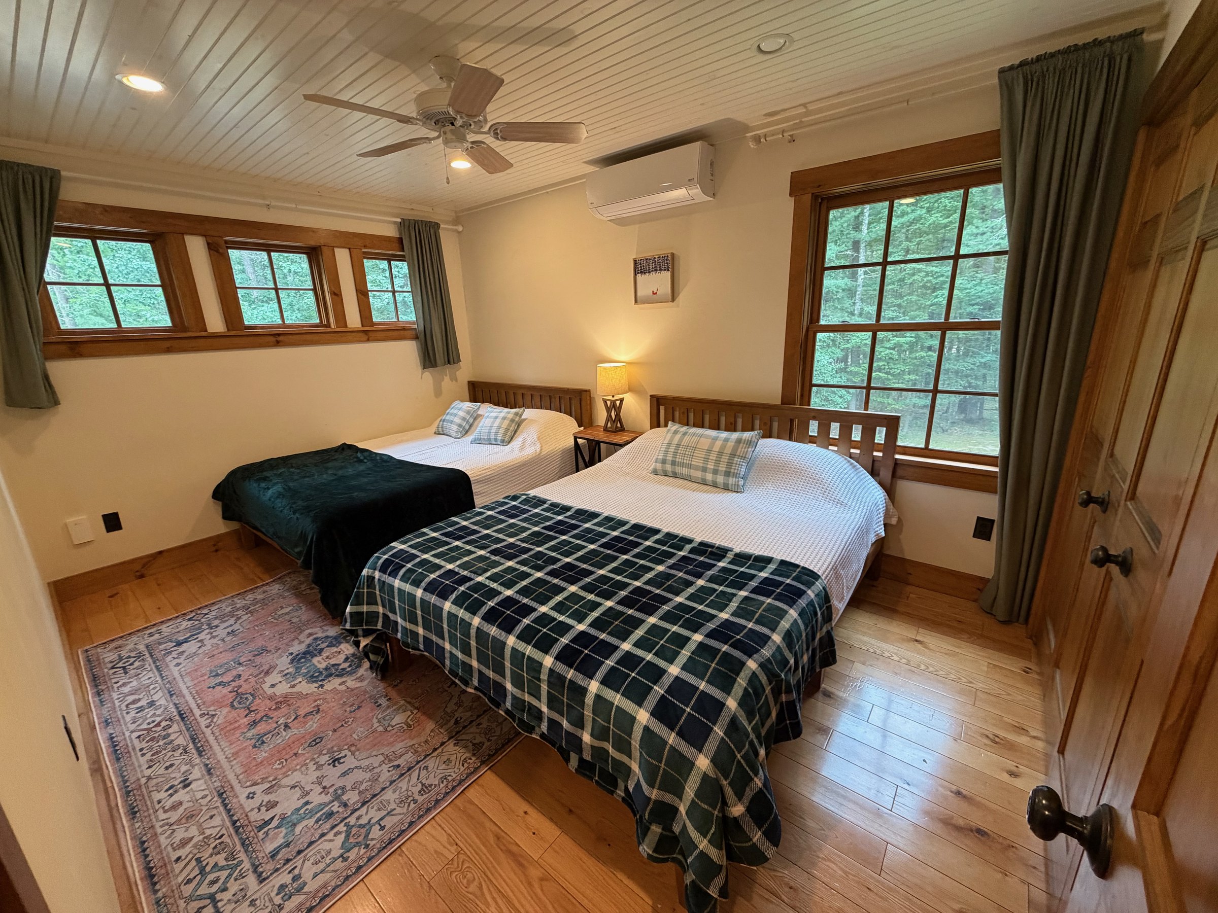 Snow Room with cozy bedding at Wild Ausable Lodge